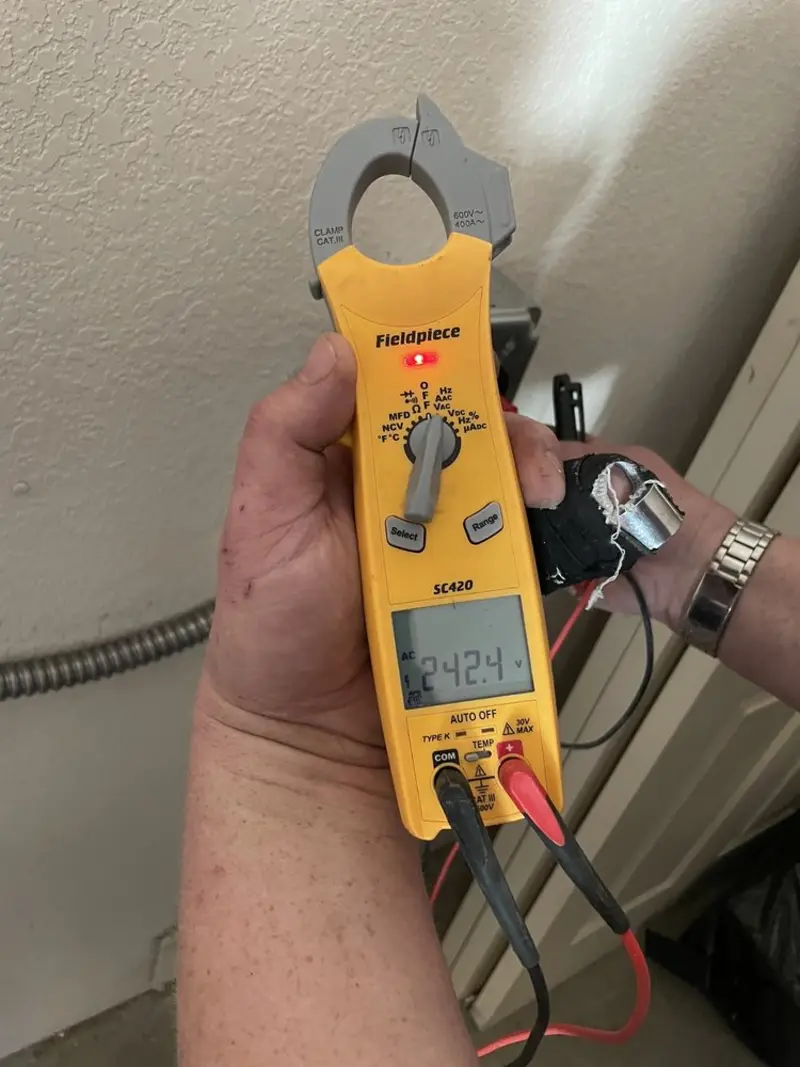 Voltage testing with clamp meter during Ceiling Fan Installation in Naples Park